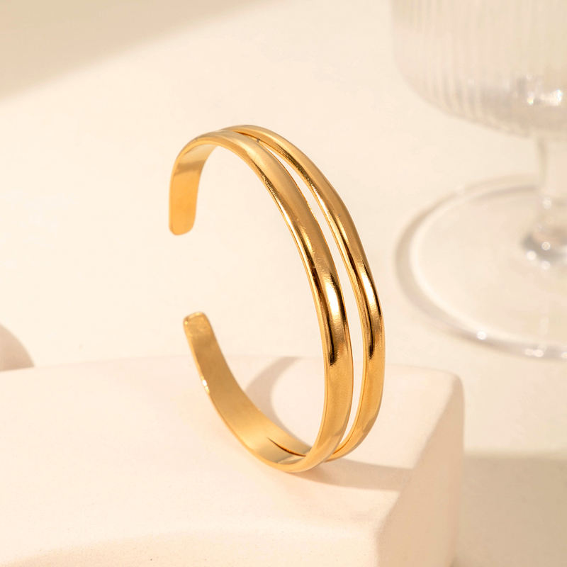 Gold bangle on a light beige background